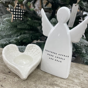 White ceramic standing angel ornament with the sentimental quote: 'Feathers appear when angels are near' Available in 2 sizes; Small 11.5cm and Large 15cm 