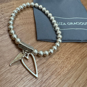 Eliza Gracious quality affordable design led branded costume jewellery&nbsp;

Stretch ball bead bracelet with twin heart charms&nbsp;
Available in Matt Burnished Silver &amp; Pale Gold&nbsp; EB0511