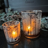 Frosted Glass Candle Holders featuring trees &amp; deer detail around the exterior
Available in 2 sizes - Small 8cm &amp; Large 12.5cm