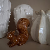 Ceramic highly glossed caramel-brown crouching Squirrel with a textured bushy tail H13cm