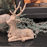 Elegant resting Reindeer figurine with detailed antlers features a textured, frosty finish with intricate, swirl-embossed scrollwork along its body H22cm&nbsp;