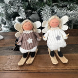 Fabric Standing skiing Angel 11cm wearing a cosy knit jumper dress with soft felt wings featuring wooden skis and ski poles
Available in 2 colours;&nbsp; White &amp; Brown&nbsp;&nbsp;