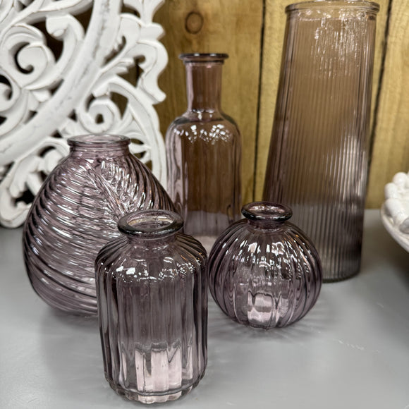 Amethyst Small Glass Bottle Vases
Various styles
Round Ribbed H8.3 x Dia 8.4cm 
Leaf pattern H13 x Dia 11cm
Tall Ribbed H22.5 x Dia 10cm
Small Ribbed - H10 x 5cm
Tall Slim Ribbed  H19 x Dia 7.5cm 