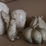 Ceramic glazed off white &amp; rustic beige tones Foraging Squirrel H20cm in an upright pose &amp; curled tail.
