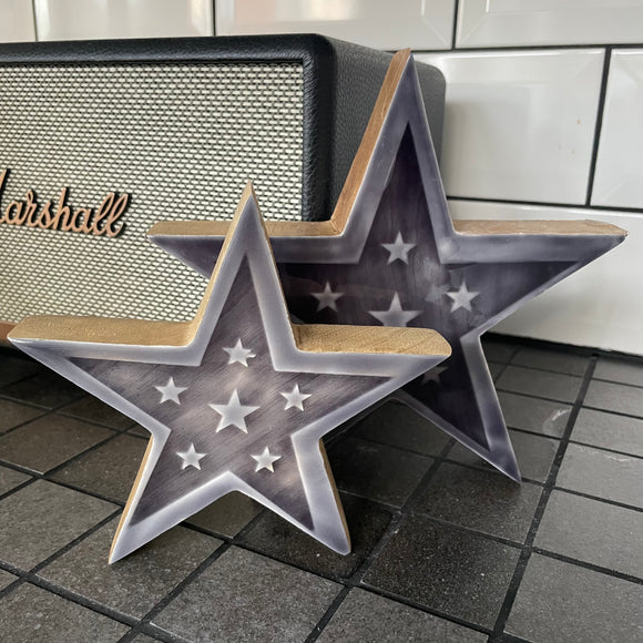 Grey Enamelled Wooden Star - Small & Large A chic star shaped decoration made from chunky mango wood. Detailed with mini stars and complete with a glossy enamel glaze