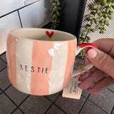 Belly Button Designs - Mabel Range
Stoneware Mug 340ml hand-painted wide, pastel pink &amp; white vertical stripes
Text stamped on the front - Bestie