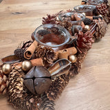 Table centrepiece with pinecones, cinnamon sticks, foliage in rich warm colours and 4 t-light cups integrated 51cm