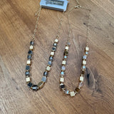 Eliza Gracious - quality affordable design led branded costume jewellery.

Short square resin &amp; metal beaded Necklace with pale gold detail &amp; chain

Available in 2 colours - Brown beads &amp; Grey&nbsp; EN0961