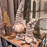 Standing Gonk with extendable legs & Sitting Gonk wearing a tall ribbed faux fur grey hat, button nose and a fluffy white beard with gold threads giving it a little sparkle 
