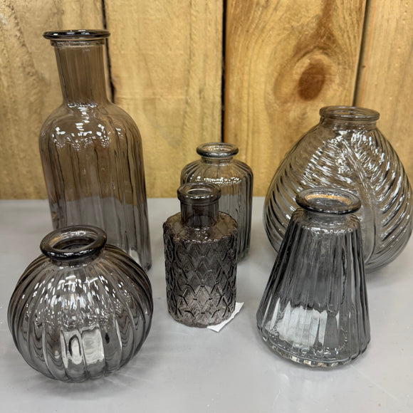 Smokey Grey Small Glass Bottle Vases
Various styles
Leaf pattern H13 x Dia 11cm

Tall Ribbed H19 x Dia 7.5cm
Mini Geometric Bottle H9cm x Dia 5cm
Round Ribbed H8.4 x Dia8.3cm
Small Ribbed H10 x 5cm
Ribbed wide base & narrow top W7.4 x H9.9cm