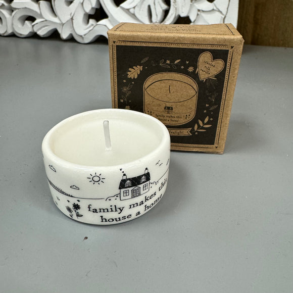 White glazed ceramic T-Light Holder with scented vanilla candle filled inside
Detailed illustration in black;  cosy home with fencing, flowers and sun shining..
Quote reads; 'Family makes this house a home'