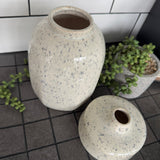 Off white/cream Glazed ceramic Round Vases with a grey speckled/fleck pattern all the way round
Available in 2 sizes; Tall H19.5cm &amp; Short Squat H8.5cm