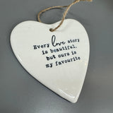 White ceramic hanging heart 10cm with a loving quote;
'Every love story is beautiful, but ours is my favourite'