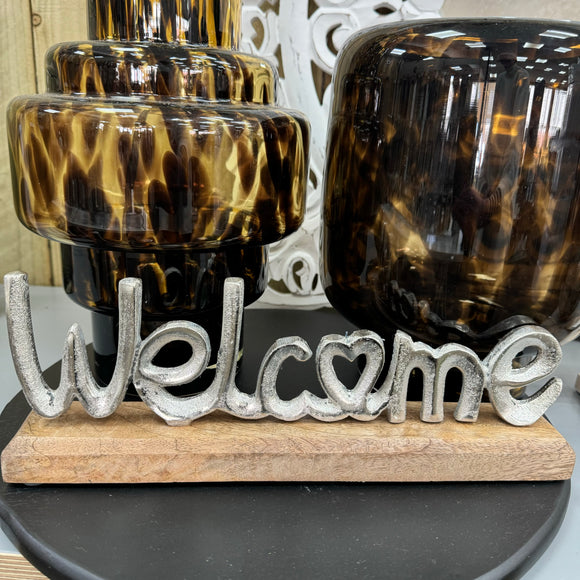 Metal 'Welcome' sign on Wooden plinth