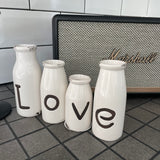 Small 13cm Distressed White glazed Ceramic Set of 4 bottles; LOVE embossed text to each & different height bottles