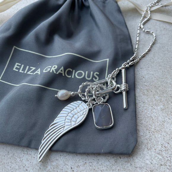 Eliza Gracious - quality affordable design led branded costume jewellery.  Silver long barrel & ball bead Necklace with Angel Wing charms pendant A lovely long detailed necklace with barrel & ball bead in silver.  EN0917