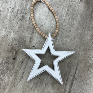 Retreat - Gifts from the heart made with love  Mango wood carved decoration with natural wooden bead hanging hoop.  Measures 12.5x12.x2.6cm beaded loop 16cm  18SS95