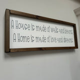 Made in the UK by Giggle Gift Co Rectangular L63.5cm Framed quotable Plaque in old white vinyl; 'A house is made of walls and beams, a home is made of love and dreams.'