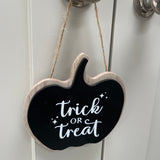 Wooden Black Hanging Pumpkin Plaque 9cm with the quote in white text; "Trick or Treat" 