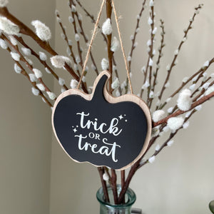 Wooden Black Hanging Pumpkin Plaque 9cm with the quote in white text; "Trick or Treat" 