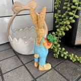 Ruth Rabbit Wearing blue dungarees & holding carrots