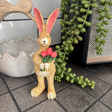Ruth Rabbit holding a bunch of bright pink Tulips H14cm