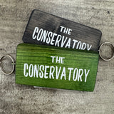 Made in the UK by Giggle Gift Co.
Wooden block keyring with white text quote on both sides;
'The&nbsp;Conservatory'&nbsp;