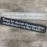 Long Wooden Hanging Plaque;
"Time to drink champagne and dance on the table!"

Made in the UK by The Giggle Gift co.