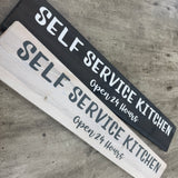 Made in the UK by The Giggle Gift co.
Long L59.5cm Wooden Hanging Plaque;
"Self Service Kitchen Open 24 hours"
