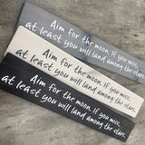 Made in the UK by The Giggle Gift co.
Long&nbsp;L59.5cm Wooden Hanging Plaque;
Quote - "Aim for the moon. If you miss, at least you will land among the stars"