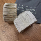 Eliza Gracious quality - affordable design led branded costume jewellery.

New SS26

Wire Wrapped Wide Cuff Slip on Bracelet
Available in 2 colours;&nbsp; Burnished Pale Gold &amp; Matt silver&nbsp;