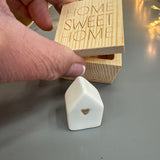 Radar&nbsp; - Lucky Wooden Small Box 4.5cm;
Quote engraved on the lid - HOME SWEET HOME
Inside the Box - Ceramic white small house with a gold heart
