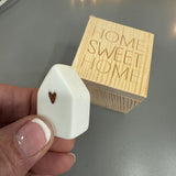 Radar&nbsp; - Lucky Wooden Small Box 4.5cm;
Quote engraved on the lid - HOME SWEET HOME
Inside the Box - Ceramic white small house with a gold heart