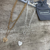 Eliza Gracious quality affordable design led branded costume jewellery

Triple-layered necklace featuring multi chain styles and a heart shaped pendant.&nbsp;

Available in Burnished Matt Silver &amp; Pale Gold