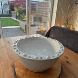 Off White Distressed Ceramic Bowl 34cm with a textured detail around the edge.