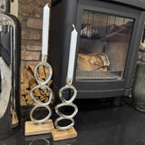 Minimal Brushed Chrome effect Candle stand with quirky oval details&nbsp;
Available in 2 sizes; Small 25cm &amp; Large 35cm