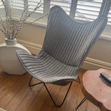 Contemporary Iron Butterfly frame Chair with a soft leather mid grey ribbed cover