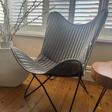 Contemporary Iron Butterfly frame Chair with a soft leather mid grey ribbed cover