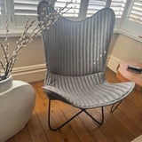Contemporary Iron Butterfly frame Chair with a soft leather mid grey ribbed cover