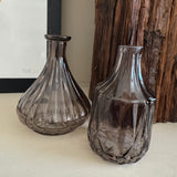 Warm Grey / Rich deep tone Glass Vase collection
Available in various sizes &amp; shapes;-&nbsp;
Ribbed &amp; wide base Bud Vase H15 x W12cm (GL44WG019) - £5.00
Diamond Shaped Small Vase H15 x W8cm (GL44WG005) - £5.00