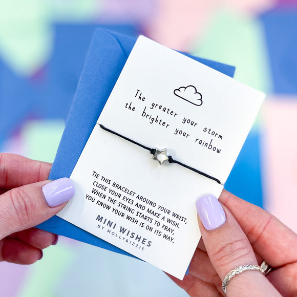 Mini Wishes by Molly & Izzie Cotton cord bracelet with a star bead presented on a card with the quote; 'The greater your storm, the brighter your rainbow' 