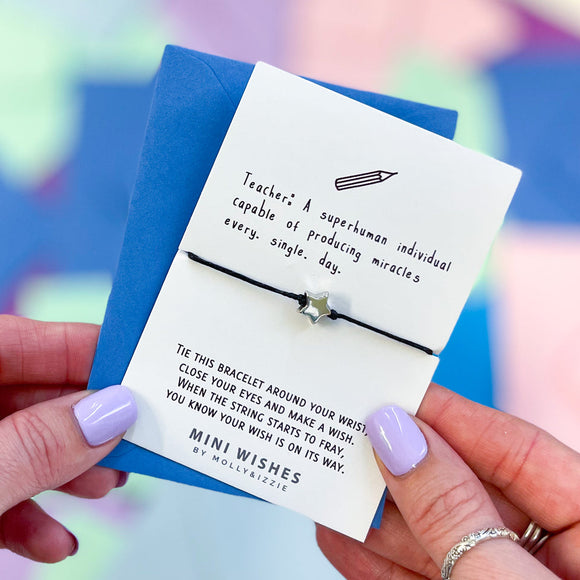 Mini Wishes by Molly & Izzie Cotton cord bracelet with a star bead presented on a card with the quote; 'Teacher: A Superhuman individual capable of producing a miracle's every single day'  Perfect little Teacher gift to show respect and thanks.