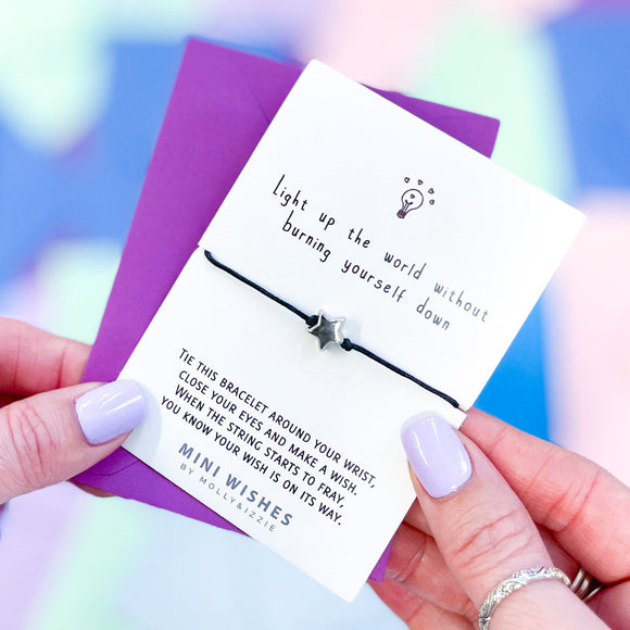 Mini Wishes by Molly & Izzie Cotton cord bracelet with a star bead presented on a card with the quote; 'Light up the world without burning yourself down' 