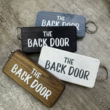 Made in the UK by Giggle Gift Co.
Wooden block keyring with white text quote on both sides;

'The Back Door'&nbsp;
