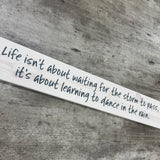 Long Wooden Hanging Sign - 'Life isn't about waiting for the storm..'