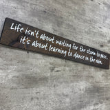 Long Wooden Hanging Sign - 'Life isn't about waiting for the storm..'