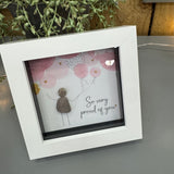 Pebble Art by La De Da Living&nbsp;

Award winning keepsake gifts - Handmade in the Cotswolds&nbsp;

Mini Framed Pebble Art - White block square frame 12.5cm
'So very proud of you'