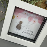 Pebble Art by La De Da Living&nbsp;

Award winning keepsake gifts - Handmade in the Cotswolds&nbsp;

Mini Framed Pebble Art - White block square frame 12.5cm
'So very proud of you'