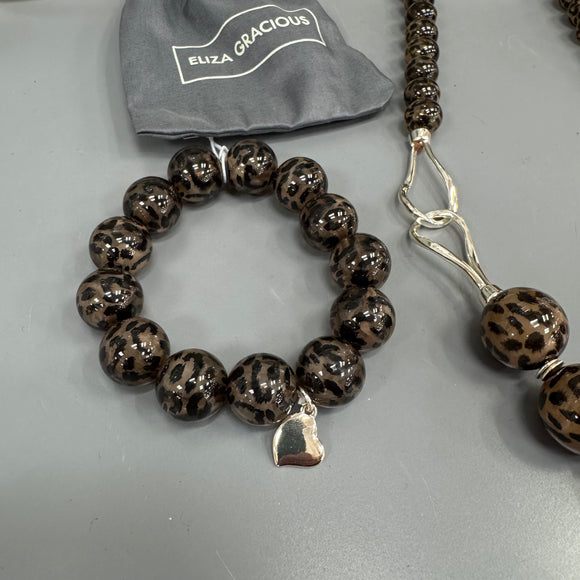 Eliza Gracious quality affordable design led branded costume jewellery

Tigers Eye effect beaded circular bracelet with heart detail 
Colour - Brown
