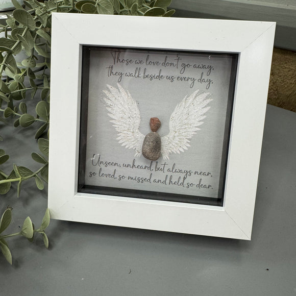Mini Framed Glitter Pebble Art - White block square frame 12.5cm
Image -pebble angel with large white glitter wings 
Quote - 'Those we love don't go away, they walk beside us every day.   Unseen, unheard, but always near, so loved, so missed and held so dear'